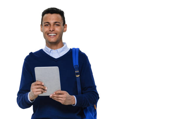istock Generation z young male standing wearing pants and using digital tablet 1203300003