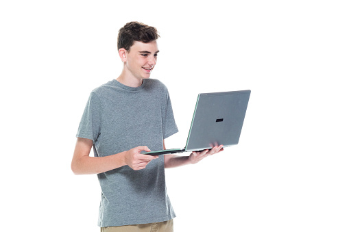 One person of aged 12-13 years old caucasian teenage boys who is working and using computer