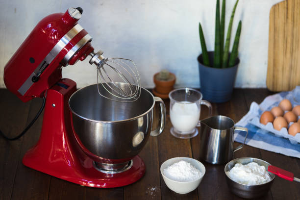 Open red standing mixer on wooden table Standing mixer with ingredients on the table electric whisk stock pictures, royalty-free photos & images