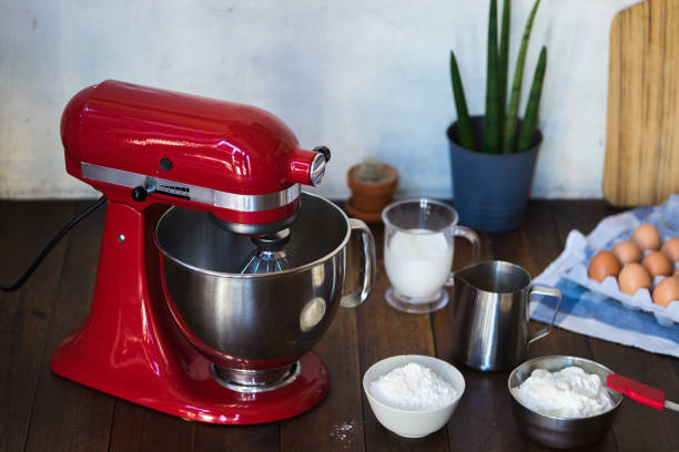 Red standing mixer Closed standing mixer on wooden table with ingredients electric whisk stock pictures, royalty-free photos & images