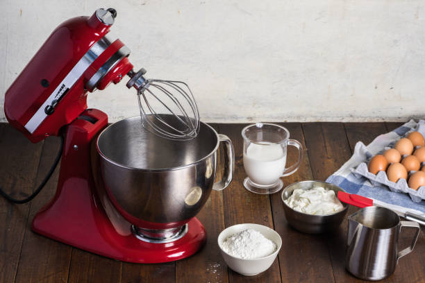 istock Red standing mixer on wooden table 1203304371