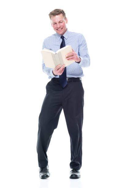 istock Caucasian male university student standing and holding textbook 1203305128