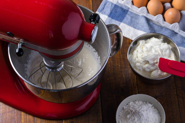 Red standing mixer whipping cream Standing mixer on wooden table with ingredients electric whisk stock pictures, royalty-free photos & images