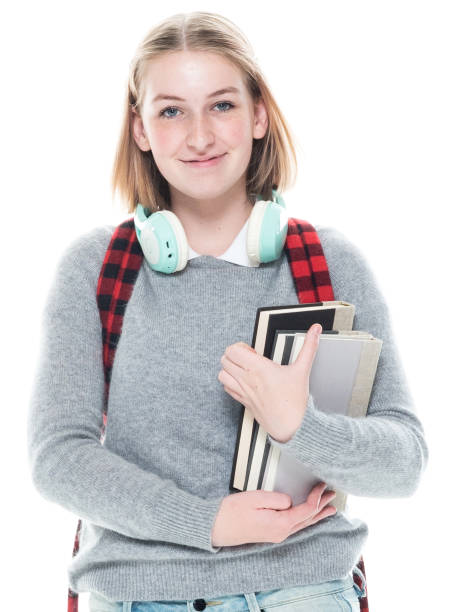 istock Generation z young women university student wearing sweater and holding textbook and using headphones 1203309071