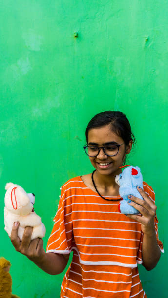 istock girl with teddy bear 1203310940
