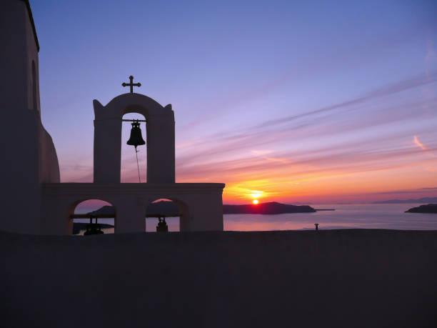 istock Sunset through the Orthodox church bell tower on Santorini 1203311927