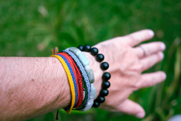 A shot of tropical bracelets on a male's wrist.
