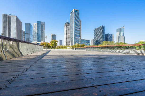 istock Empty wooden floor with modern buildings background 1203313325