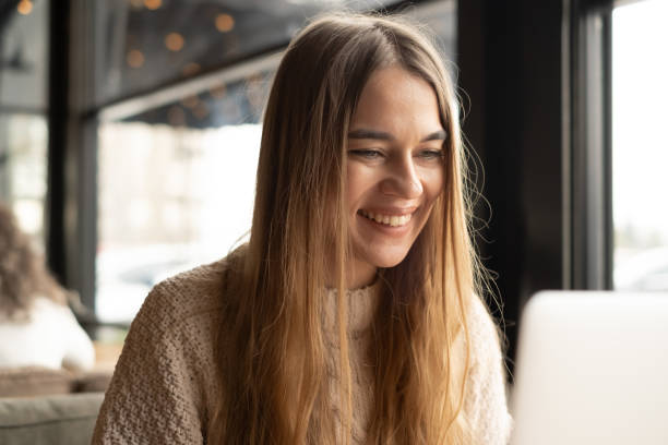 istock Young woman using laptop in a coffe shop. 1203318043
