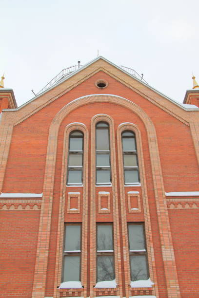 istock Fragment of a red brick church with windows 1203319318