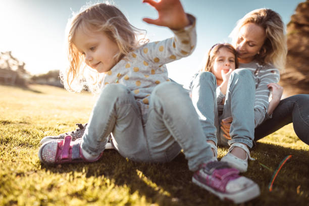 istock mother enjoy at the park with daughters 1203320010