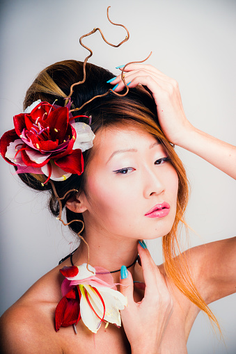 Close-up portrait of beautiful Korean woman wearing national flowers in hairs.