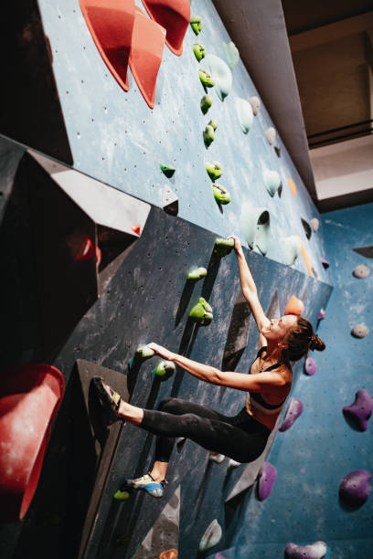 istock Muscular woman on boulder climbing training 1203322717