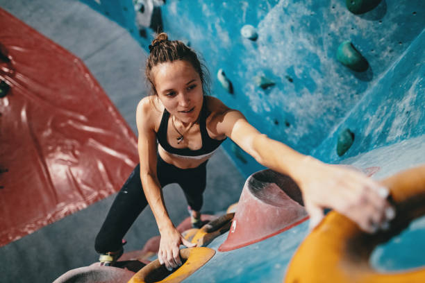 istock Muscular woman on boulder climbing training 1203324483
