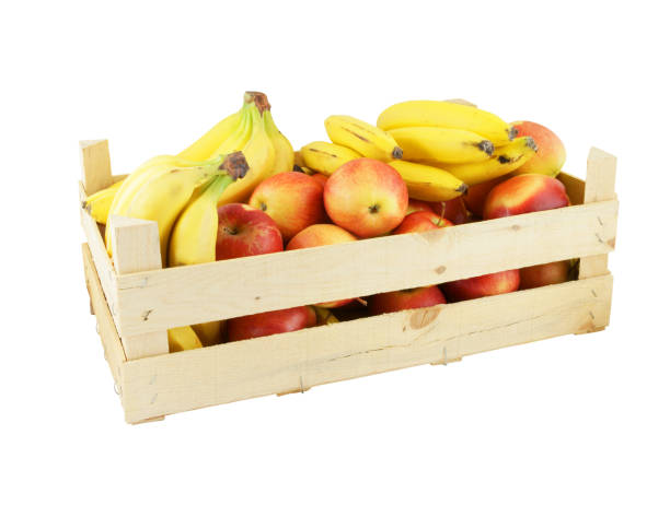 istock Wooden crate with apples and bananas isolated on white 1203326711