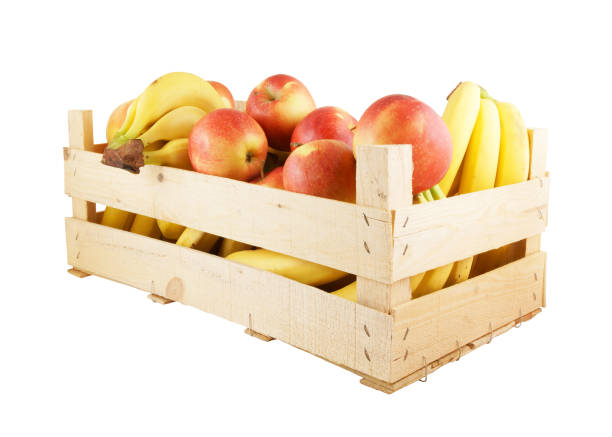 istock Wooden crate with apples and bananas isolated on white 1203326712