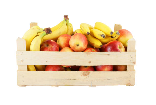 istock Wooden crate with apples and bananas isolated on white 1203326717