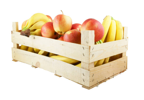 istock Wooden crate with apples and bananas isolated on white 1203326728