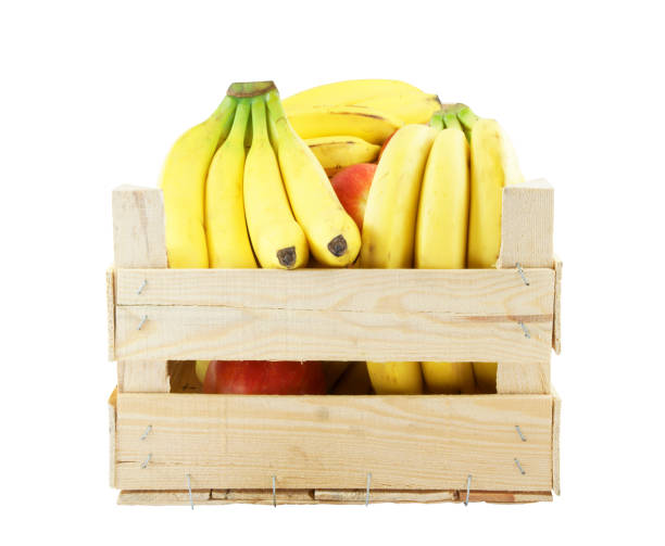 istock Wooden crate with apples and bananas isolated on white 1203326748