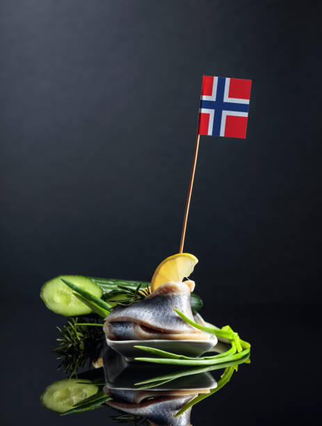istock Norwegian herring with lemon, green cucumber, onion and rosemary. 1203327749