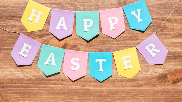 istock Happy Easter background with colorful paper flags on wood 1203329665