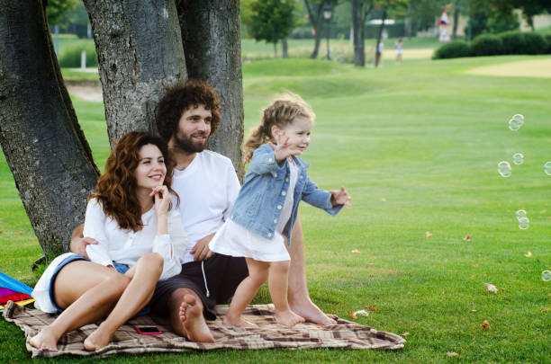 istock Happy young family in the park 1203330208