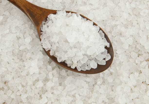 istock Wooden spoon on coarse sea salt 1203330217