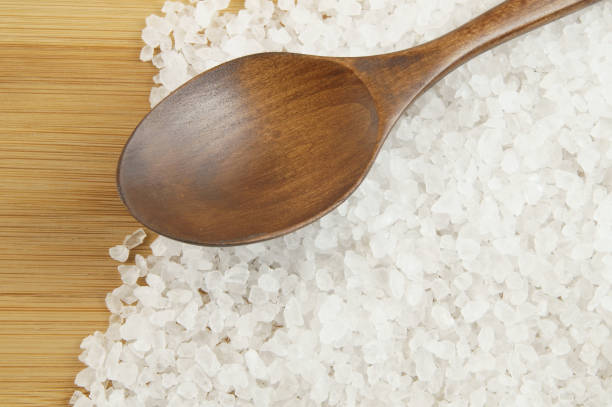 istock Salt and wooden spoon on table 1203330260