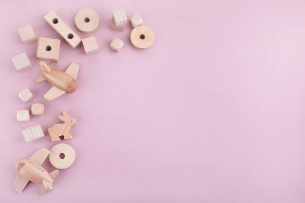 istock Zero waste. Frame from eco wooden toys on pink background. Flat lay. Top view 1203330433