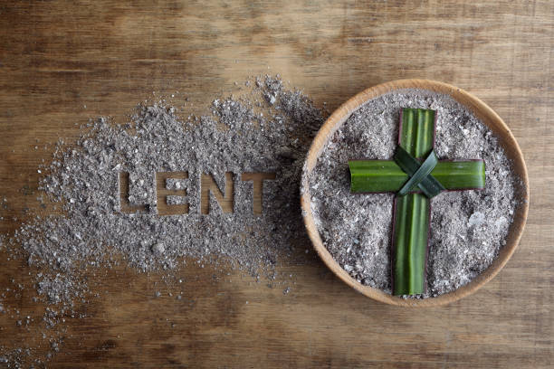 Lent word written in ash, dust as fast and abstinence period concept. Top view Lent word written in ash, dust as fast and abstinence period concept. lent stock pictures, royalty-free photos & images