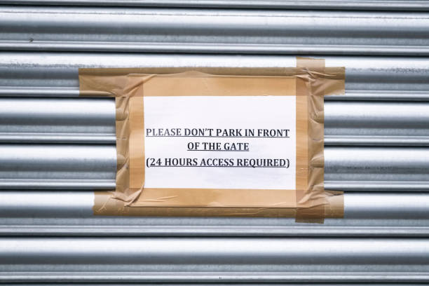 istock No parking keep clear sign with gate entrance door at constant use 1203332095