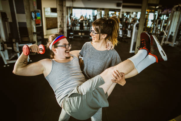 istock Funny athletic couple having fun in a gym. 1203332616