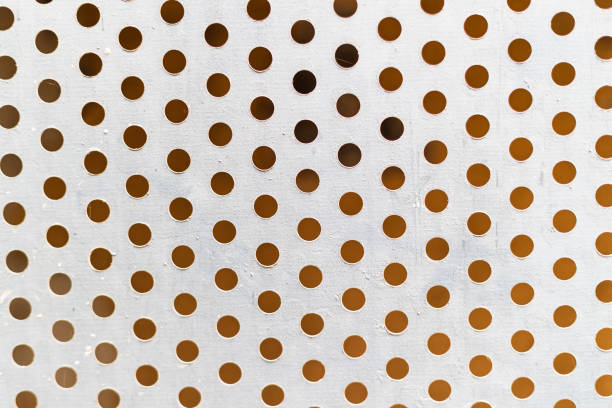 Many round holes on white metal plate