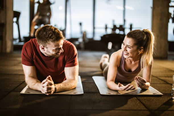 istock Happy athletic couple talking on a break in a gym. 1203333238