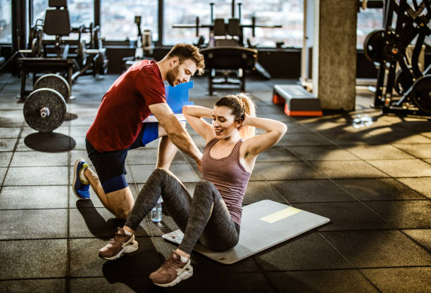 exercitando abturações com um treinador em uma academia! - sit ups - fotografias e filmes do acervo