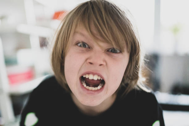 istock Portrait of a young boy with a scowl 1203334352