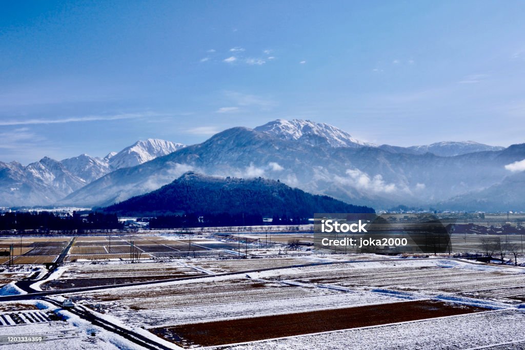 Snow capped mountains and paddy dields Urasa area @ Niigata Niigata Prefecture Stock Photo