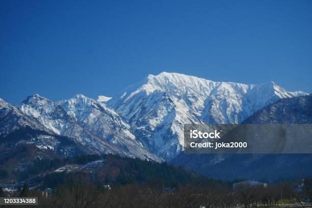 Snow Capped Mountains Stock Photo - Download Image Now - Japan, Niigata Prefecture, Winter
