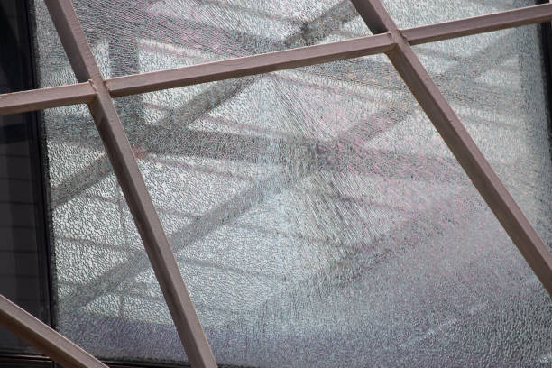istock broken safety glass background and texture.  cracked tempered glass restaurant window. 1203334532