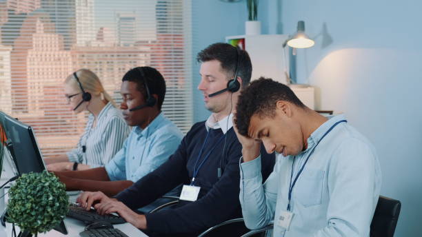 istock Multiracial call center agent feeling exhausted and broken-down after telephone call with the client 1203336587