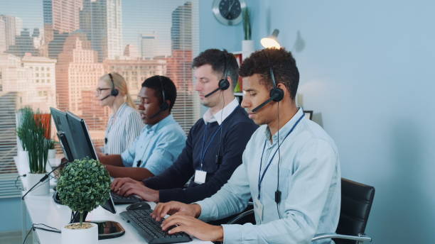 istock Multiracial call center agents talking to the clients in headset 1203336883