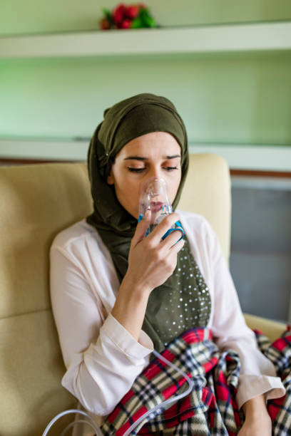 istock Young woman is using an asthma inhaler 1203337924