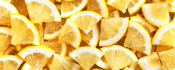 istock Slices of fresh lemon in sugar. Background and texture. Panorama. 1203339440