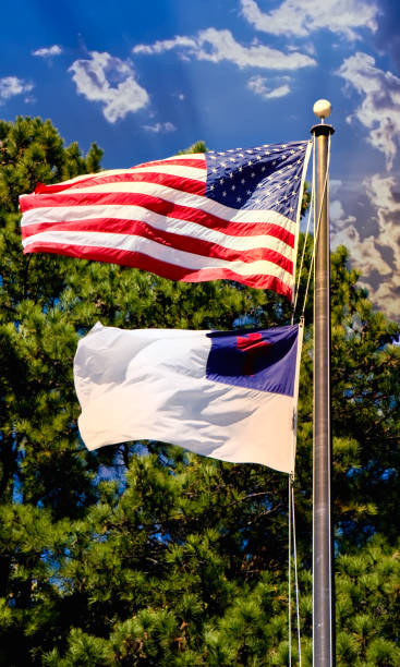 istock Christian and American Flag On Sunny Sky 1203339630