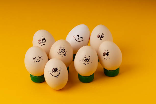 istock Chicken Eggs With Smileys For Easter Painting on yellow background . Happy Easter concept 1203342149