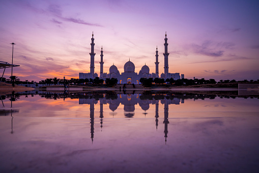Panoramic view of Sheikh Zayed Grand Mosque, Abu Dhabi, United Arab Emirates at sunset and dusk. The third biggest mosque in the world.