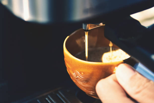 istock Espresso pouring from coffee machine. Barista Cafe Making Coffee Preparation Service Concept, Close-up 1203344594