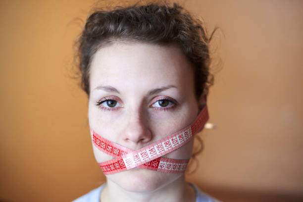 istock Sad woman with wrapped face meter around face. 1203345505