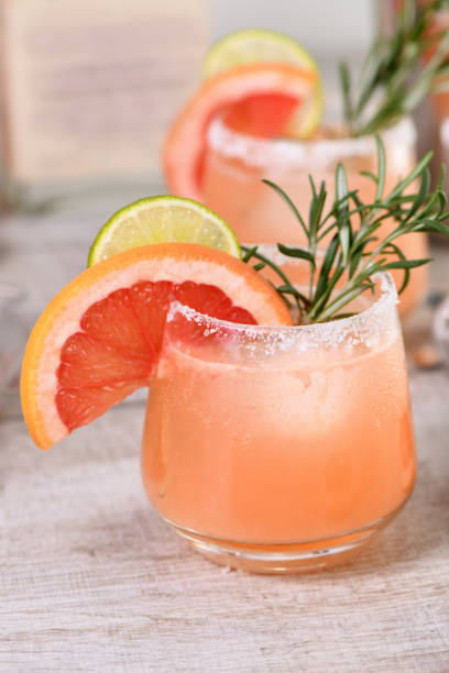 Cocktail fresh lime and rosemary combined with fresh grapefruit juice and tequila. A festive drink is ideal for brunch, parties and holidays. stock photo