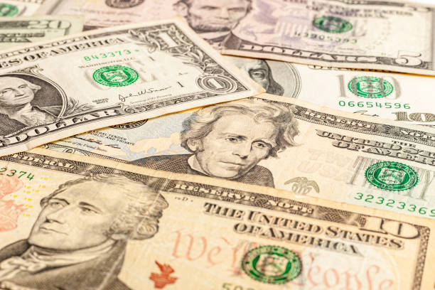 istock Close-up of multiple American dollar banknotes. 1203345688